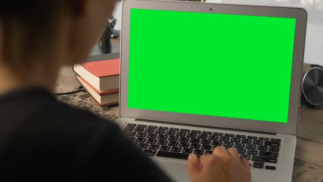 4K: Woman working at home on with laptop green screen