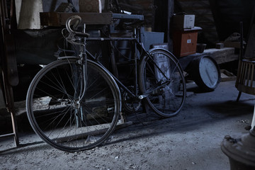 Obraz na płótnie Canvas A vintage bicycle inside an old dirty cellar