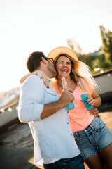 Fototapeta premium Happy young dancing couple having fun and enjoying party at summer