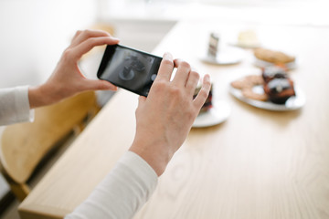 Woman vlogger recording video for food channel. Cooker shef recording a video for vlog with a phone