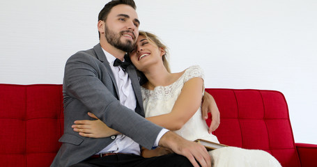 The lovers give flowers to the bride and kissed happy and couple love standing in wedding studio