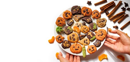 Halloween gingerbread cookies, pumpkin, ghost, skeleton for trick or treat Halloween party in October, homemade cookies with cinnamon spice and herb for autumn season on white background copy space