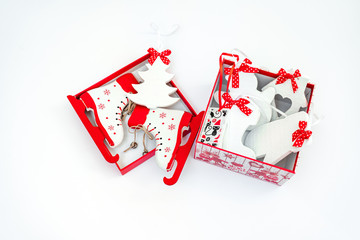 decorative box with wooden Christmas tree toys. Christmas tree, Snowman, skates, mitten. Isolated on white background, close-up