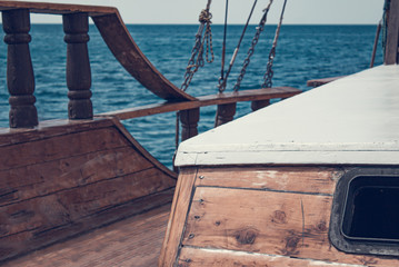 View from the front of the old wooden ship. The bow of a vintage ship. Window in cabin and the lower deck an ancient ship.