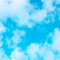 Abstract background, design template with copy space. Vibrant teal blue sky with soft white clouds