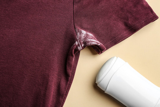 Clothes With Stain And Deodorant On Beige Background, Closeup