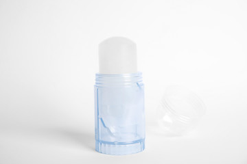 Fototapeta na wymiar Natural crystal alum stick deodorant and cap on white background