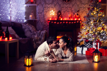 Beautiful husband and wife in dim light celebrating christmas