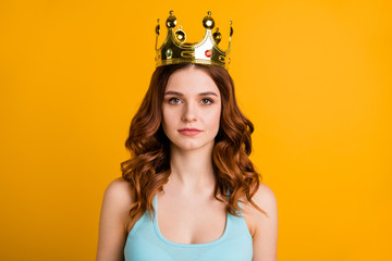 Photo of foxy not smiling lady wear tank-top and big golden crown isolated yellow background