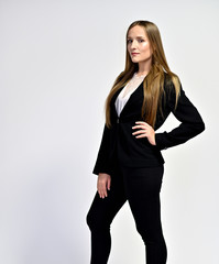 Business photo portrait of a young woman in a business suit on a light background. Well-groomed hair, slim figure. It is in different poses.