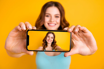 Photo of foxy lady holding telephone making selfies for instagram followers wear tank-top isolated...
