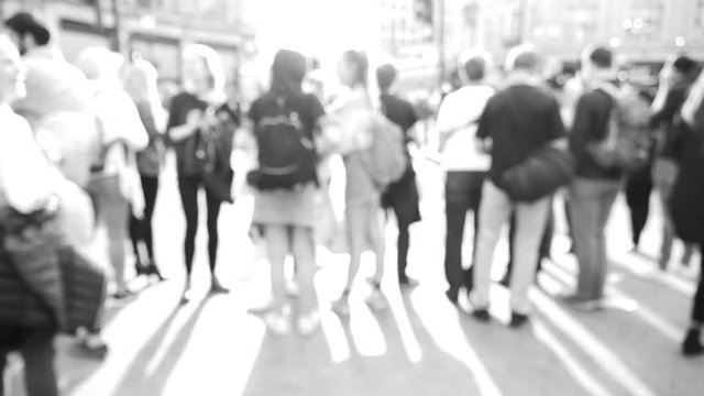 Blur defocused silhouettes of pedestrians people walking in slow motion on Oxford Circus interchange between the Bakerloo, Central and Victoria lines flare cinematic HD footage