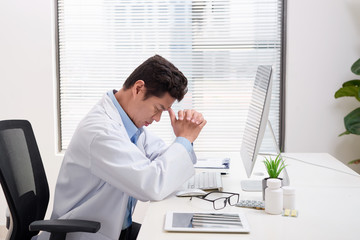 Overworked doctor sitting in his office