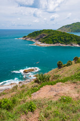 Fototapeta na wymiar Phuket Promthep Cape View Point Famous tourist attractions in Thailand On a clear day, the blue sky contrasts with the white clouds. And the blue sea and the waves in the sea