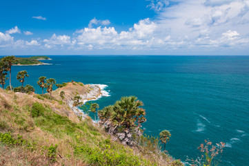 Phuket Promthep Cape View Point Famous tourist attractions in Thailand On a clear day, the blue sky contrasts with the white clouds. And the blue sea and the waves in the sea