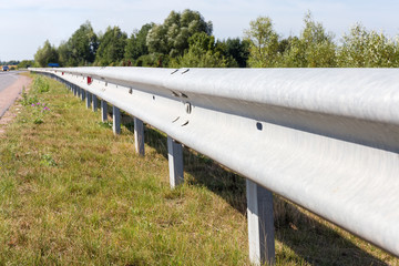 Steel beams road crash barrier on the roadside of roadway