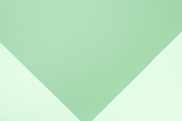 Background in trendy mint color. Fashionable pink and ornage paper. Top view. Minimal concept. Trendy mint color of year 2019.