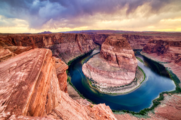 Horseshoe Bend on Colorado River at Sunset with Dramatic Cloudy Sky, Utah