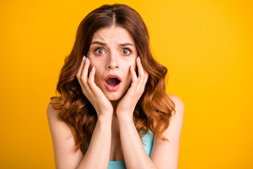 Close up photo of horrified frightened girlfriend feared with something being about to cry and shout wearing turquoise singlet while isolated with vibrant yellow color background