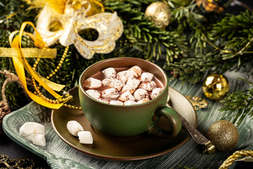 Christmas composition with hot chocolate milk drink with marshmallows and festive decoration. Holiday greeting card concept.