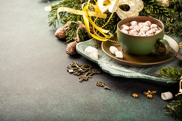 Christmas composition with hot chocolate milk drink with marshmallows and festive decoration. Holiday greeting card concept with copy space.