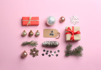 Flat lay composition with Christmas decor on light pink background