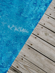 wooden platform on swimming pool background. top view. Procurement, a template for design with place for text. Old boards and a lake copy space.