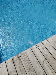 Fototapeta na wymiar wooden platform on swimming pool background. top view. Procurement, a template for design with place for text. Old boards and a lake copy space.