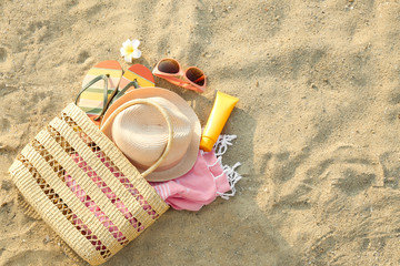Composition with beach accessories on sand, flat lay. Space for text