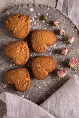 Biscuit hearts. Crispy and crumbly delicious cookies with natural ingredients: flour, nuts, seeds, pieces of chocolate, cocoa, fruit jams. Spring flower still life