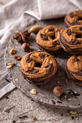 Сhocolate nut biscuit. Crispy and crumbly delicious cookies with natural ingredients: flour, nuts, seeds, pieces of chocolate, cocoa, fruit jams. Spring Flower Still Life