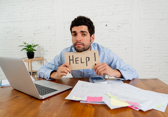 Overwhelmed young man paying bills trying to manage home business finances asking for help