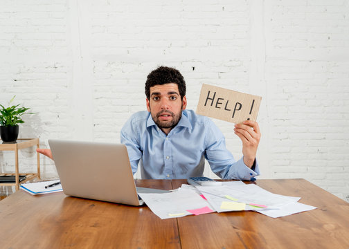 Overwhelmed young man paying bills trying to manage home business finances asking for help