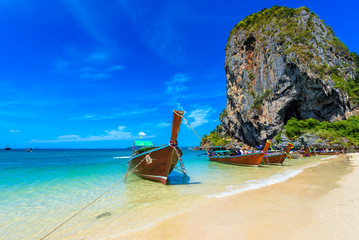 Limestone karst rocks at Ao Phra Nang Beach with Thai traditional wooden longtail boat on Railay Peninsula, close to Ao Nang, Krabi province, Andaman Sea, Thailand