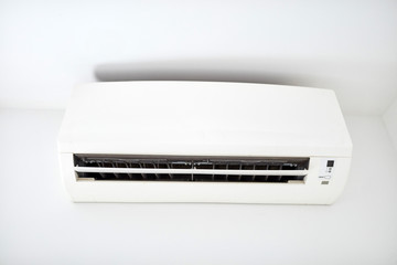 Moder air condition unit on a white wall inside the living room.