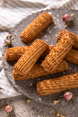 Biscuit sticks with fruit filling. Crispy and crumbly delicious cookies with natural ingredients: flour, nuts, seeds, pieces of chocolate, cocoa, fruit jams. Spring Flower Still Life