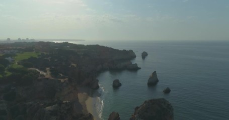 Aerial view of Praia dos Tres Irmaos (Three Brothers beach) in Alvor, famous tourist destination in Western Algarve Coast, Portugal.