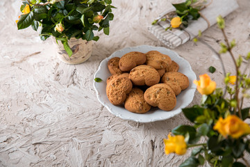 Biscuit hearts. Crispy and crumbly delicious cookies with natural ingredients: flour, nuts, seeds, pieces of chocolate, cocoa, fruit jams. Spring flower still life
