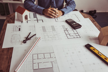 Architect Engineer Working with Blueprints in the office.concept