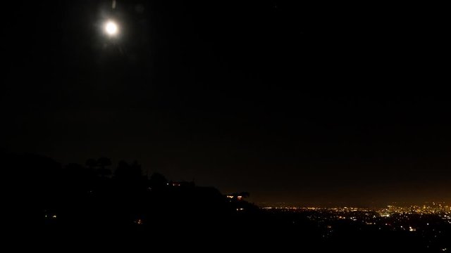 Night to day timelapse with a full moon overlooking Berkeley and Oakland.