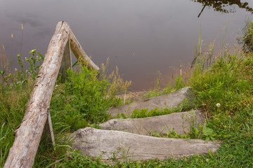 Wooden stairs in a rural pond