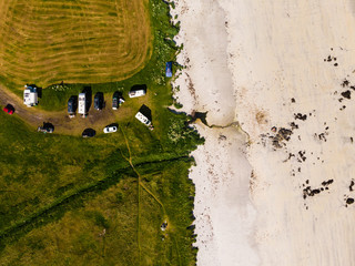 Aerial view. Sandy beach with parking area