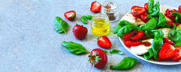 Summer salad with strawberries and mozzarella. Italian caprese salad with strawberries.
