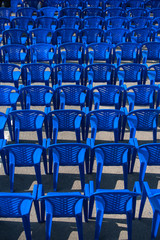 Fototapeta premium blue chairs stand on the street for a concert.