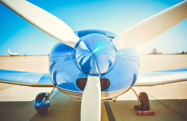 Sport airplane propeller. Little plane in the airport. Aviation background.