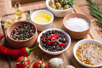 Fresh salad ingredients (salt, pepper, olive, tomato, rosemary, oil )