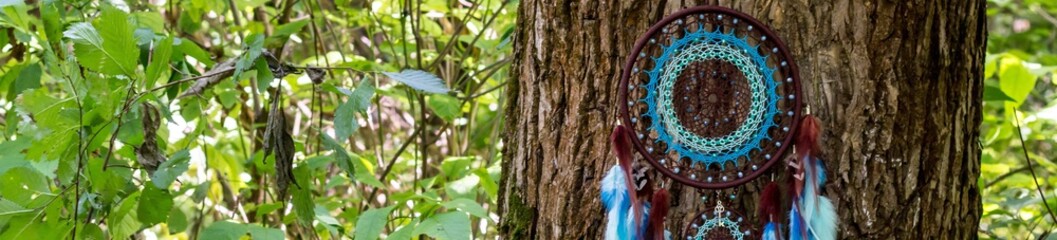 banner of Handmade dream catcher with feathers threads and beads rope hanging
