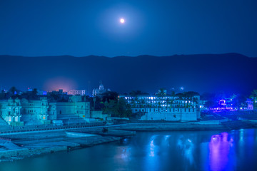 Night sky with full moon and Mars over old Pushkar at Pushkar Lake from Ram Ghat at Pushkar, Rajasthan, India