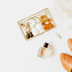 Feminine fashion composition with stylish accessories: leather shoes, earrings, perfume, flower bouquet on white background. Flat lay, top view trendy minimal lifestyle concept.