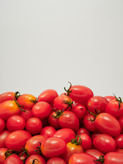 Fresh cherry tomatoes on white background
